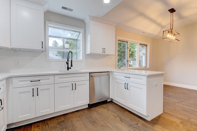 kitchen featuring dishwasher, hardwood / wood-style floors, white cabinetry, and decorative light fixtures