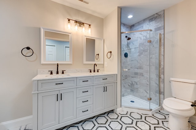 bathroom with vanity, toilet, a shower with door, and tile patterned floors