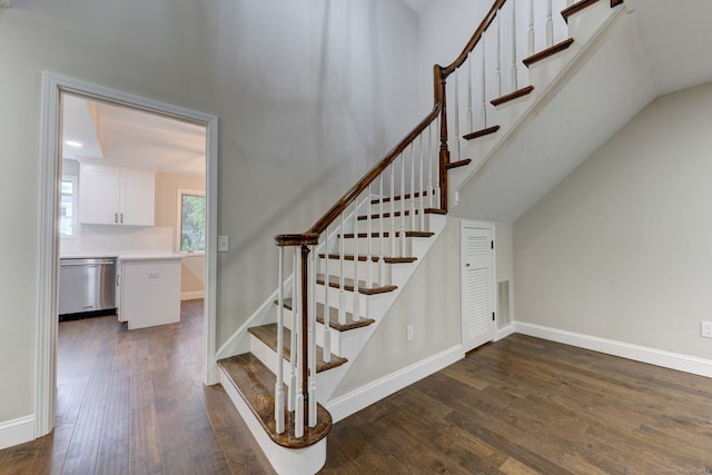 staircase featuring lofted ceiling and hardwood / wood-style floors