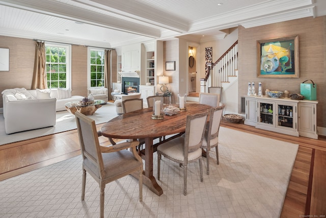 dining area featuring crown molding and light hardwood / wood-style floors