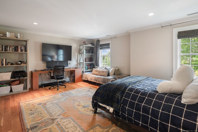 bedroom with wood-type flooring and crown molding