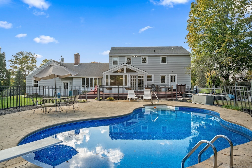 view of pool featuring a patio area and a diving board