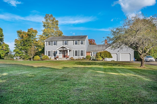 colonial-style house with a garage and a front lawn