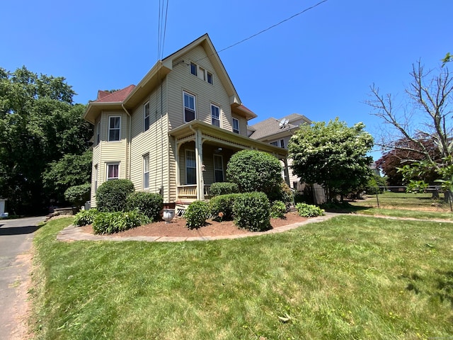 view of side of property with a lawn