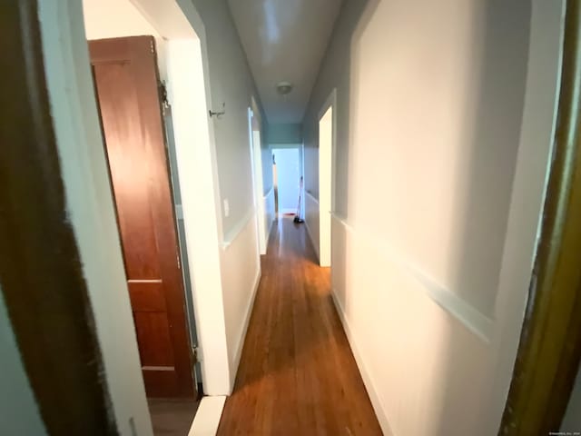 corridor with hardwood / wood-style floors