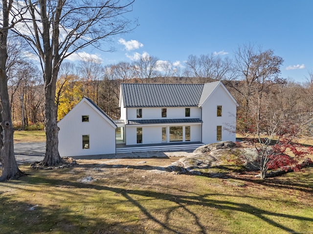 back of property featuring a yard