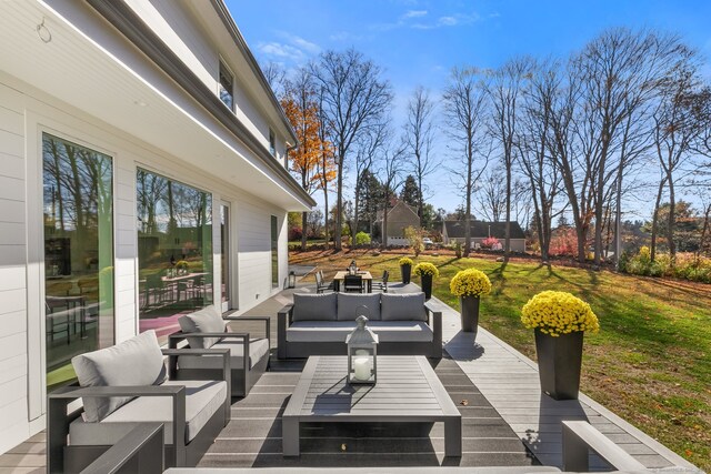 wooden deck with an outdoor hangout area and a yard