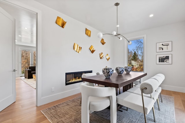 dining space with plenty of natural light and light wood-type flooring