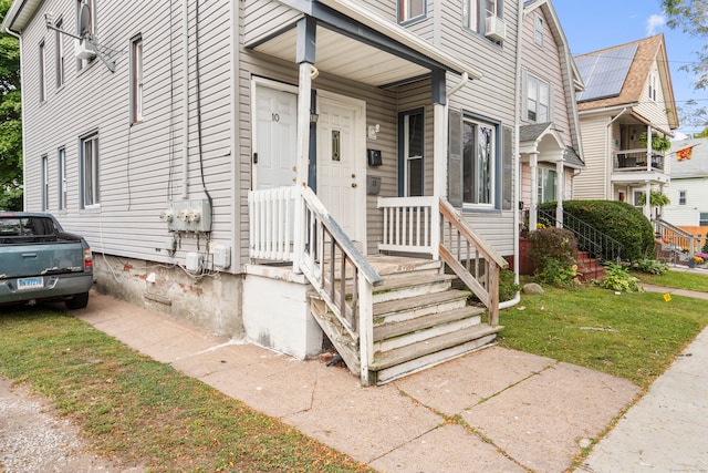 entrance to property with a lawn