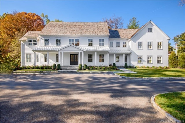 view of front of house with covered porch and a front yard