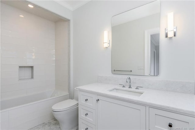 full bathroom featuring tiled shower / bath, vanity, crown molding, toilet, and tile patterned floors