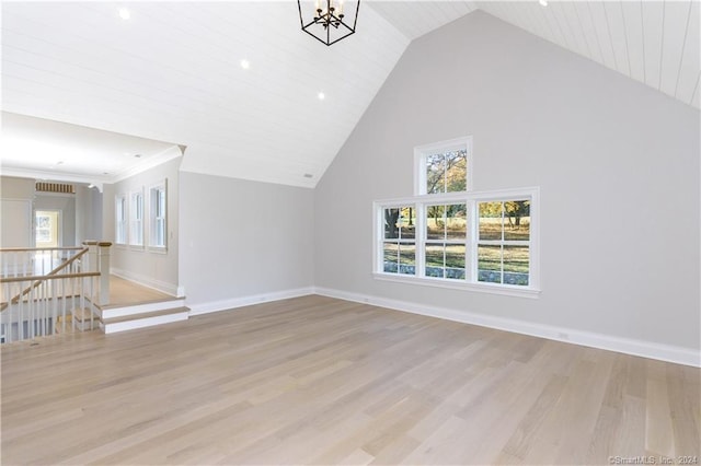 unfurnished living room featuring an inviting chandelier, light hardwood / wood-style flooring, high vaulted ceiling, and wooden ceiling