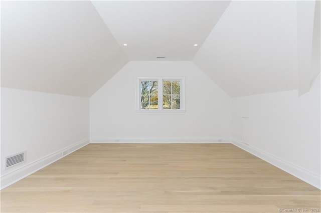 bonus room featuring light hardwood / wood-style flooring and lofted ceiling