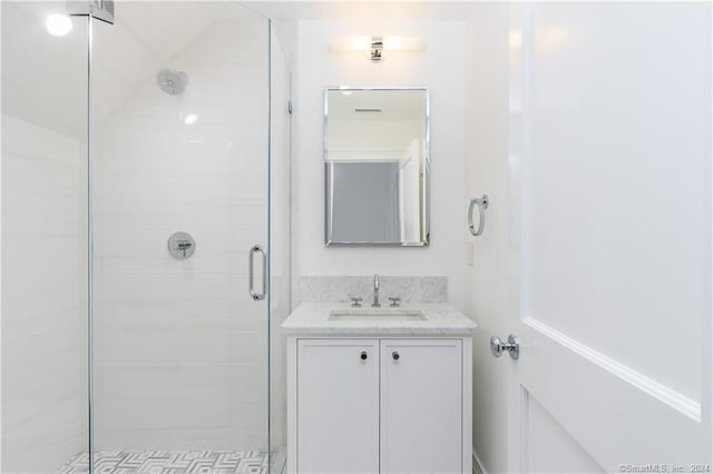 bathroom featuring an enclosed shower and vanity