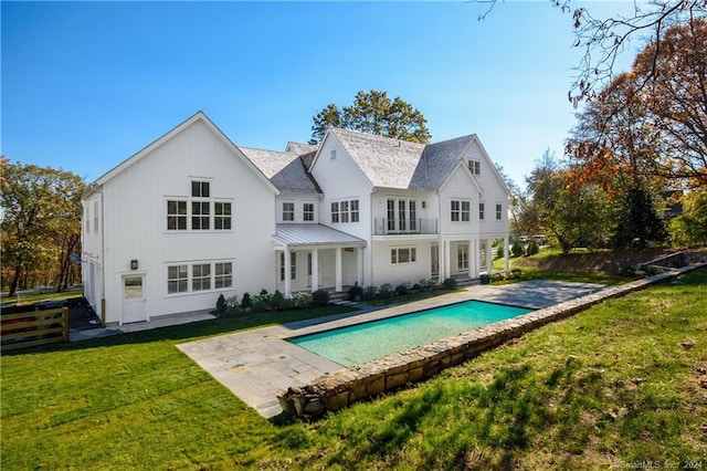 rear view of property with a patio and a yard