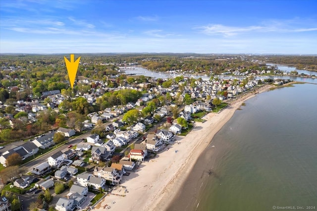 bird's eye view featuring a water view and a beach view