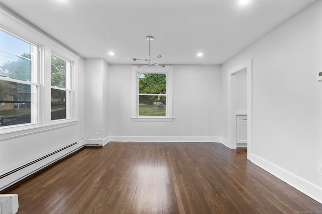 unfurnished room featuring an inviting chandelier, a baseboard radiator, dark hardwood / wood-style flooring, and a wealth of natural light