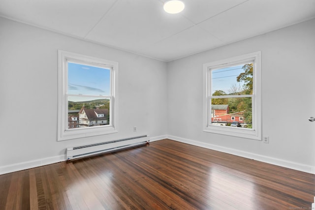 unfurnished room featuring wood-type flooring and baseboard heating