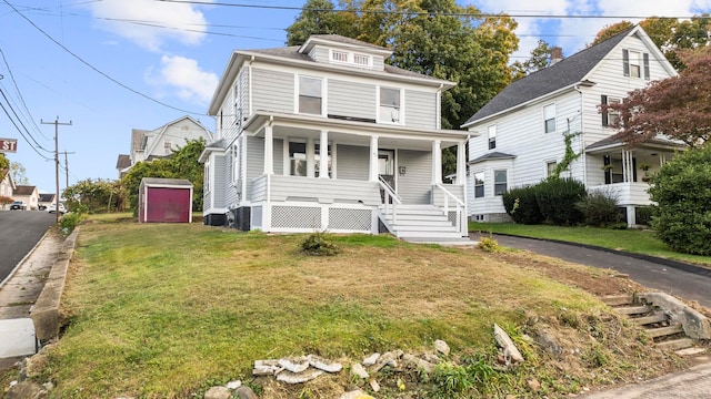 view of front facade with a front lawn and covered porch