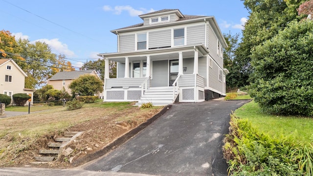 view of front of house with a front lawn and covered porch