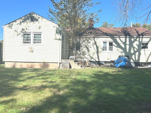 14 8th St, Newington, CT 06111 - back of house featuring a lawn and a chimney