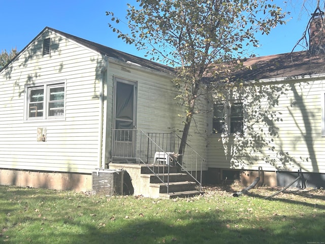 exterior space with a yard and central AC unit