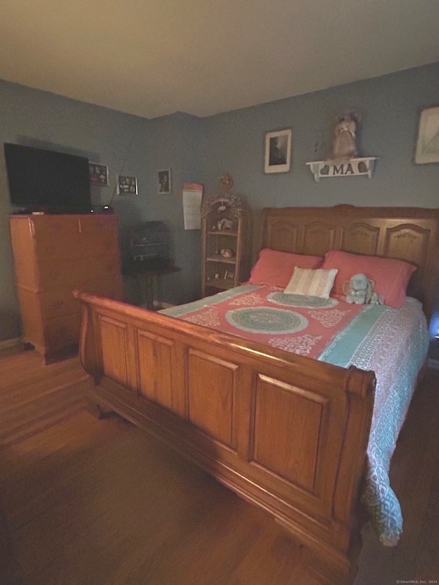 bedroom featuring dark hardwood / wood-style flooring