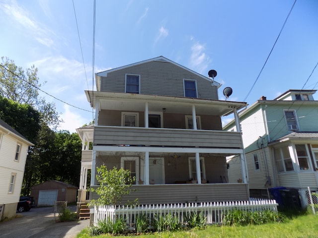 view of front facade with an outdoor structure, a garage, and covered porch