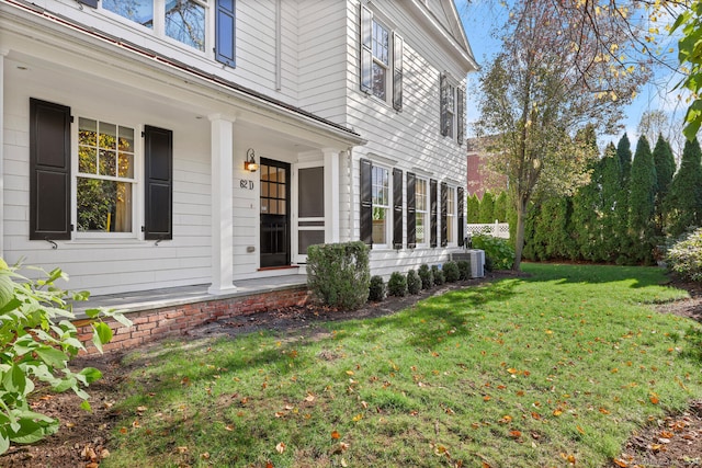 exterior space featuring cooling unit and a yard