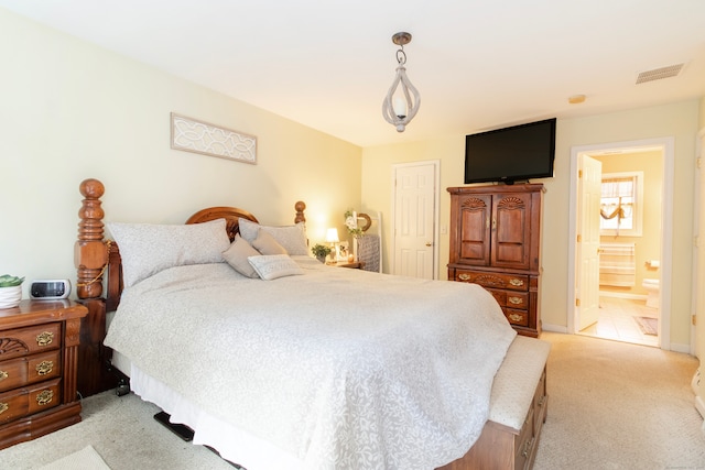 carpeted bedroom featuring connected bathroom