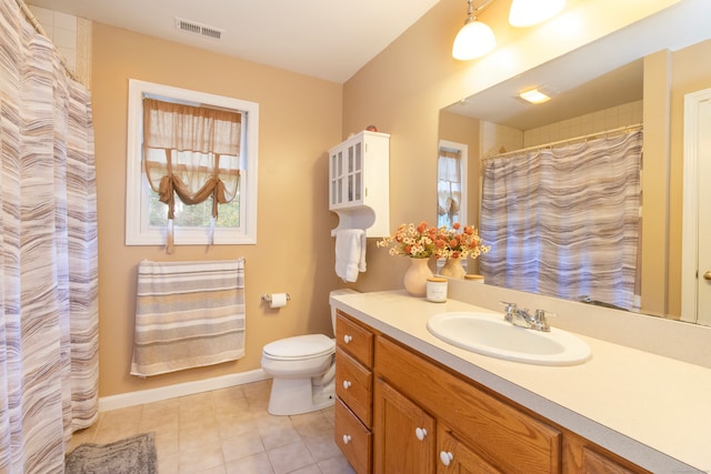 bathroom with tile patterned flooring, vanity, and toilet