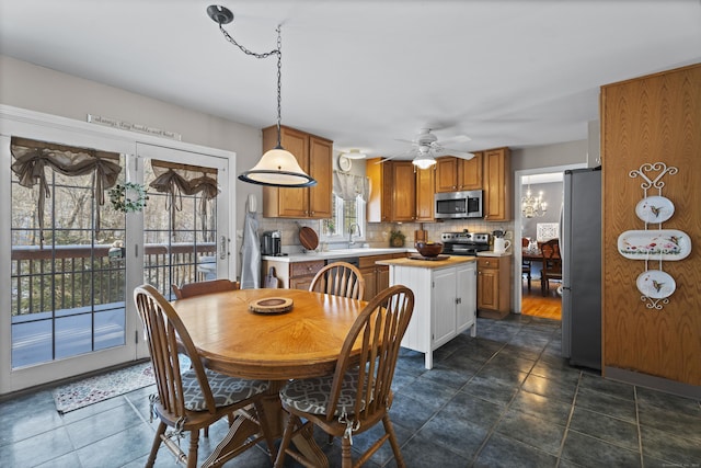 dining room featuring sink and ceiling fan