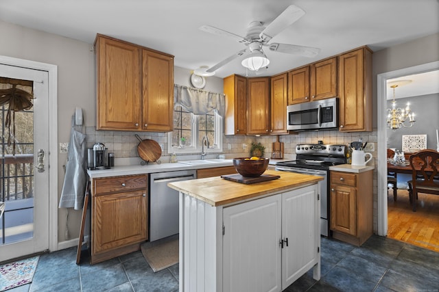 kitchen featuring wooden counters, appliances with stainless steel finishes, sink, and backsplash