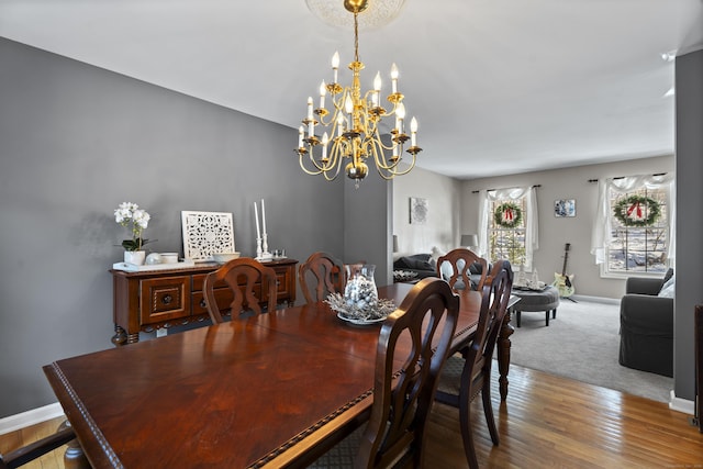 dining area featuring an inviting chandelier and hardwood / wood-style floors