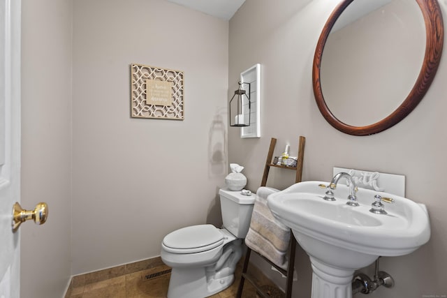 bathroom featuring sink, tile patterned floors, and toilet