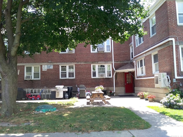 view of front of house with a patio and ac unit