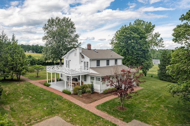 429 Chestnut Land Rd, New Milford, CT 06776 - rear view of house with roof with shingles, a chimney, a deck, and a lawn
