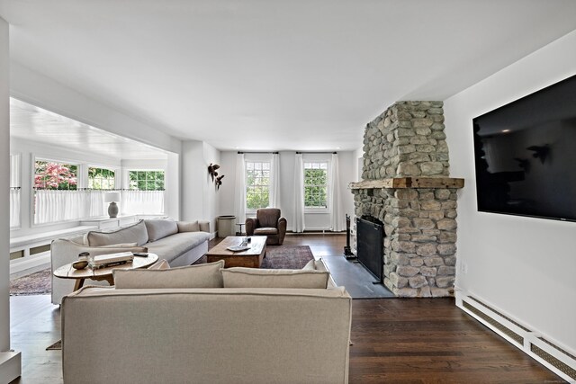 429 Chestnut Land Rd, New Milford, CT 06776 - living area featuring a baseboard heating unit, dark wood finished floors, and a stone fireplace