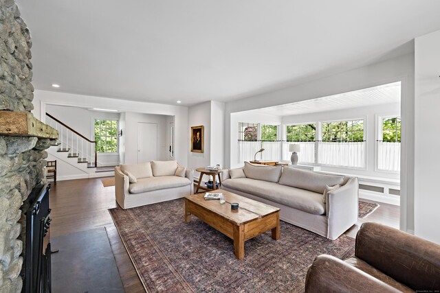 429 Chestnut Land Rd, New Milford, CT 06776 - living room featuring a wealth of natural light, a fireplace, dark wood-style flooring, and stairs