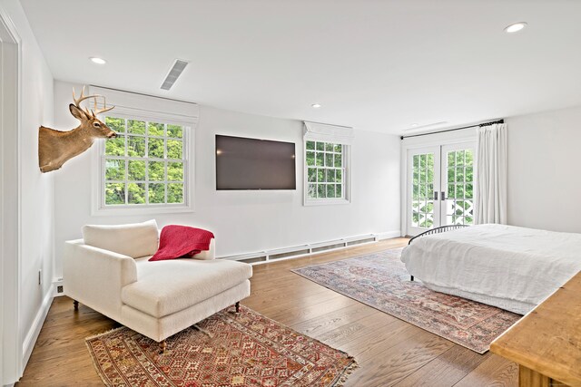 429 Chestnut Land Rd, New Milford, CT 06776 - bedroom with visible vents, recessed lighting, baseboard heating, wood finished floors, and french doors