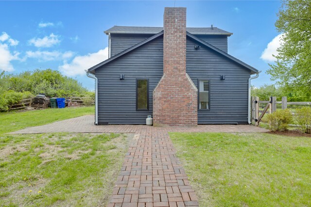 429 Chestnut Land Rd, New Milford, CT 06776 - back of property featuring a yard, a patio area, and a chimney
