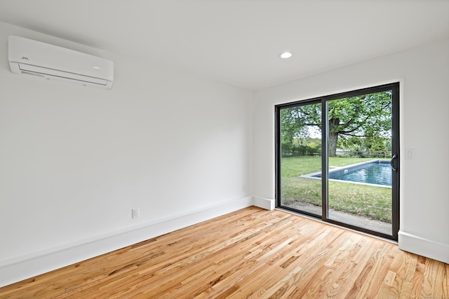 429 Chestnut Land Rd, New Milford, CT 06776 - unfurnished room featuring an AC wall unit, baseboards, recessed lighting, and wood finished floors