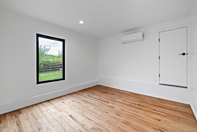 429 Chestnut Land Rd, New Milford, CT 06776 - spare room featuring an AC wall unit, baseboards, light wood finished floors, and recessed lighting