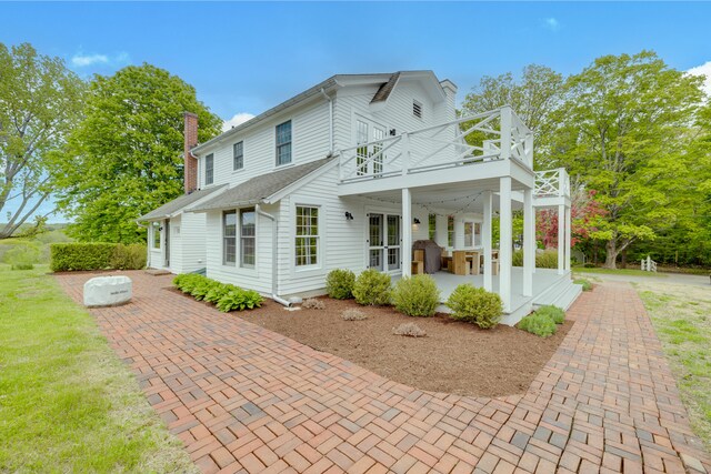 429 Chestnut Land Rd, New Milford, CT 06776 - exterior space featuring a patio, a chimney, a shingled roof, and a deck