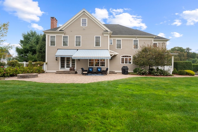 rear view of property with a patio and a yard