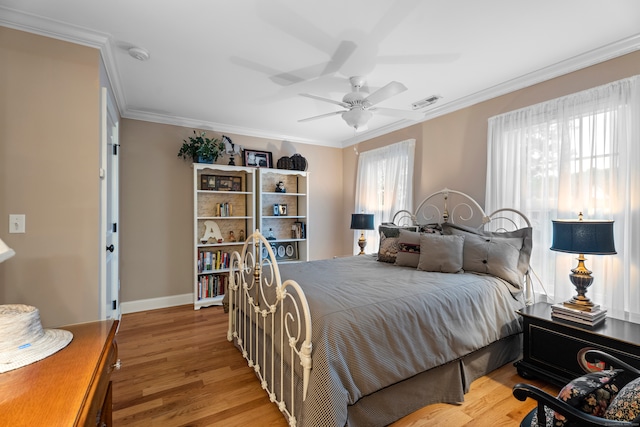 bedroom featuring wood-type flooring, crown molding, and ceiling fan