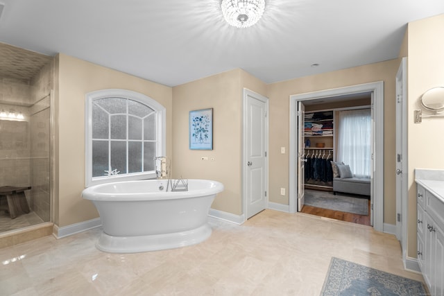 bathroom featuring shower with separate bathtub and vanity