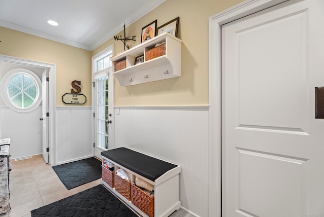 mudroom featuring ornamental molding, light tile patterned floors, and a wealth of natural light