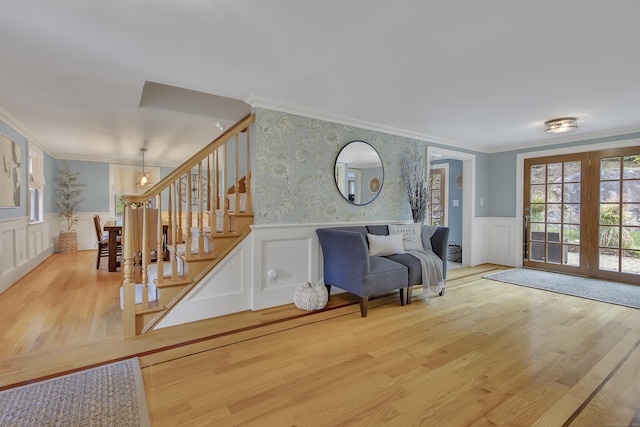 living area featuring ornamental molding and hardwood / wood-style flooring