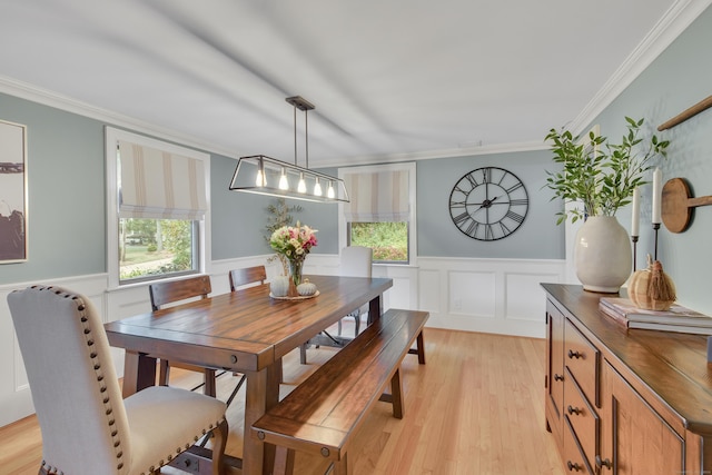 dining room featuring light wood-type flooring and ornamental molding